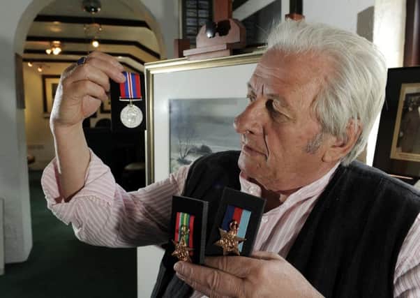 Ashley Jackson with his father's medals.  Picture by Bruce Rollinson