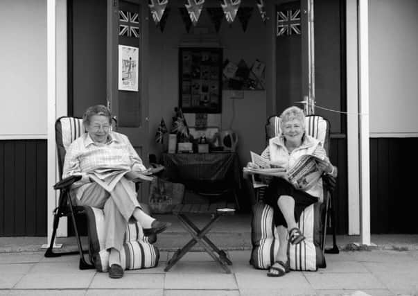 0167 - Two women sit outside their beach hut, Filey, North Yorkshire.