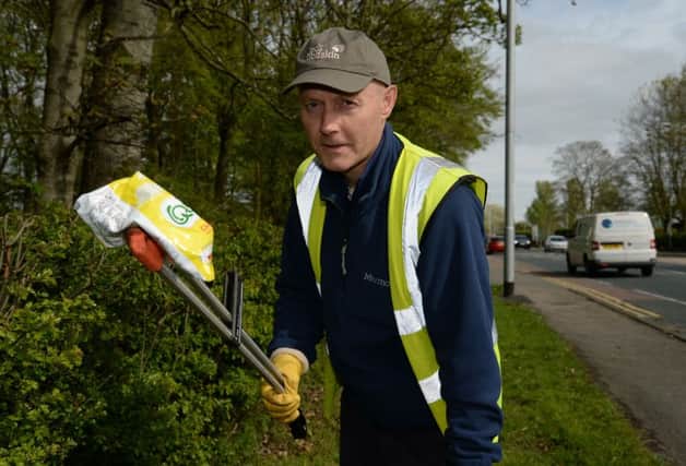 Jeff Yates, coordinator of Litter Free Guiseley, picks litter from the roadside in Guisley. Picture: Anna Gowthorpe