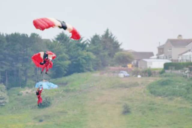 BEST QUALITY AVAILABLE

Handout photo dated 19/06/15 courtesy of Stephen Miller of members of the British Army freefall parachute display team, the 'Red Devils' who were performing at the Whitehaven Air Show on the Cumbrian coast last night, when a team members chute failed to open - leaving a team-mate to catch him in mid-air and bring him to safety. PRESS ASSOCIATION Photo. Issue date: Saturday June 20, 2015. See PA story AIR Devils. Photo credit should read: Stephen Miller/PA Wire

NOTE TO EDITORS: This handout photo may only be used in for editorial reporting purposes for the contemporaneous illustration of events, things or the people in the image or facts mentioned in the caption. Reuse of the picture may require further permission from the copyright holder.