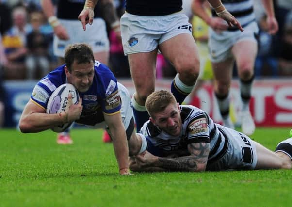 Hull's Marc Sneyd tackles Leeds's Danny McGuire.
