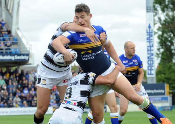 Rhinos' Stevie Ward looks to offload against Hull FC.