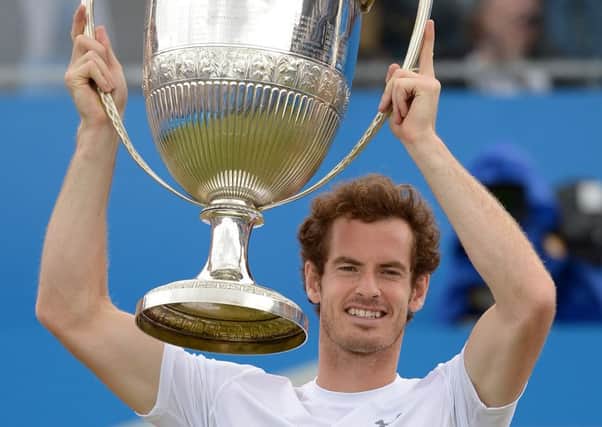 Great Britain's Andy Murray holds aloft the Queen's trophy.