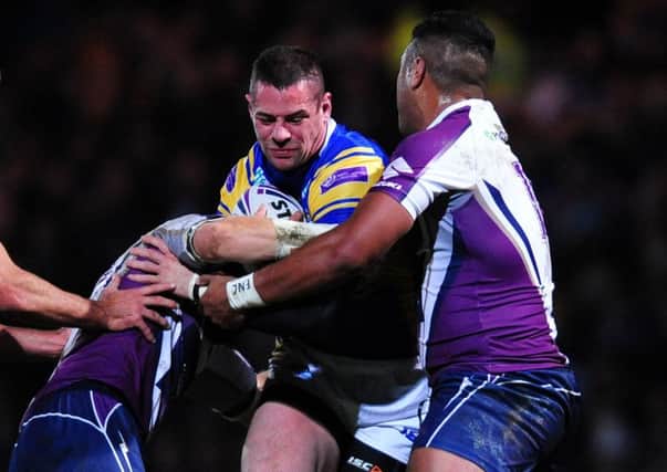 Leeds Rhinos' Ian Kirke is tackled by Melbourne Storm's Ryan Hinchcliffe (left) and Siosaia Vave during the World Club Challenge at Headingley in 2013.