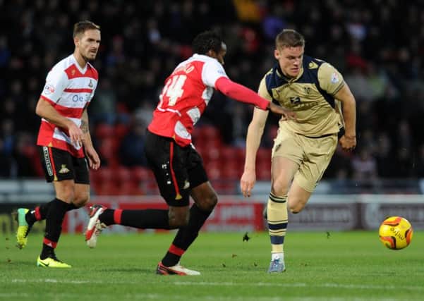 Bongani Khumalo and Matt Smith chase the ball during a recent Doncaster and Leeds clash at the Keepmoat Stadium on December 14, 2013. (
Picture: Bruce Rollinson)