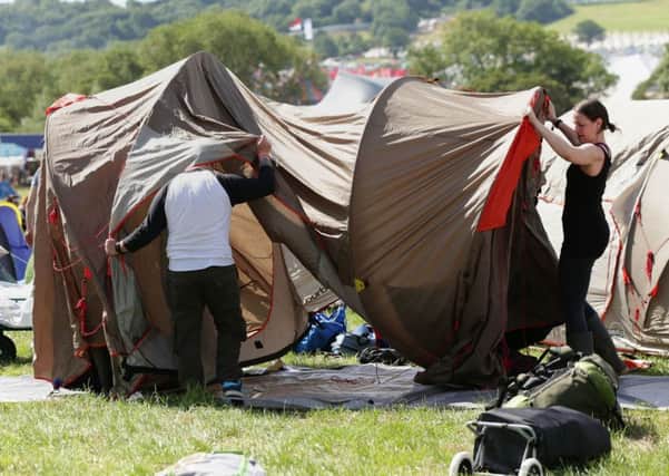 Festivalgoers pitch their tents at the Glastonbury Festival, at Worthy Farm in Somerset. PIC: PA