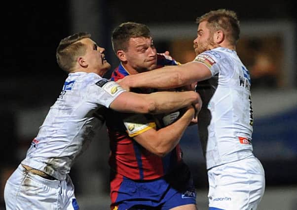 Catalans' Elliot Whitehead hits the Wakefield defence