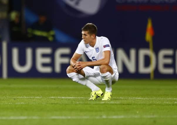 Barnsley-born John Stones looks dejected after defeat and elimination for the England Under-21s in the Czech Republic Picture: Matthias Schrader/AP).