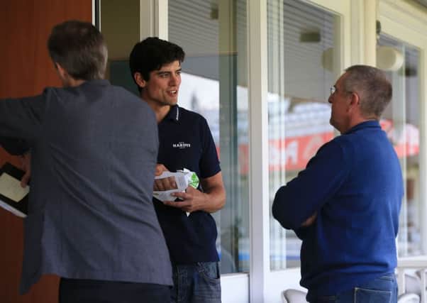England's Alastair Cook (centre) speaks with head coach Trevor Bayliss (right) at Lord's.