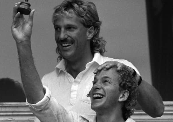 England captain David Gower holds a replica of the Ashes trophy and is congratulated by Ian Botham after winning the sixth Test and the 1985 series. main Picture: PA