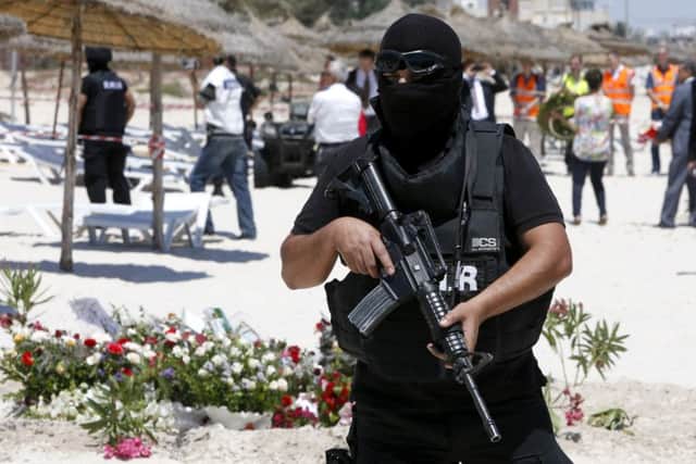 Tunisian police guards at the scene of Friday's shooting attack
