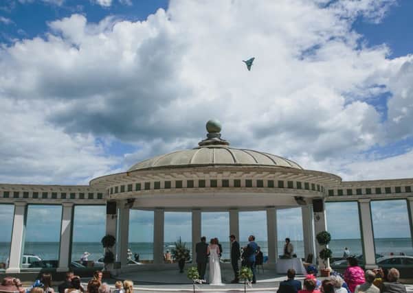 Jonny and Emily Smith on their wedding day, getting photo bombed by the Vulcan. Picture: Mark Tierney/Ross Parry Agency