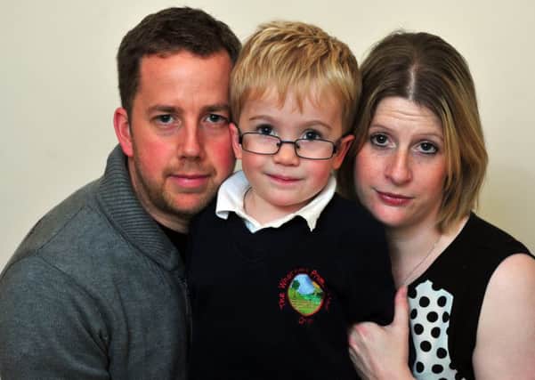 Sam Brown, 6, with  parents Katy and Simon from Otley.