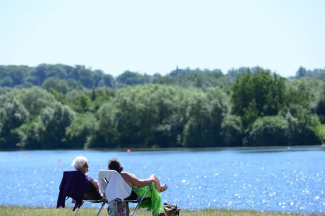 Visitors enjoy the sunshine at Pugneys Country Park in Wakefield. Picture: Scott Merrylees