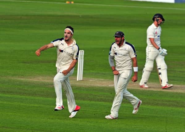 Yorkshire's Jack Brooks celebrates with Tim Bresnan after taking the wicket of Durham's Michael Richardson. Picture: Tony Johnson.