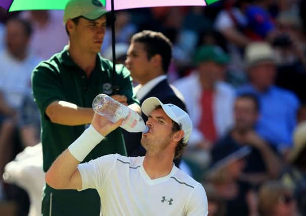 British No 1 Andy Murray gulps down water on Centre Court yesterday where the ground temperature measured 43 degrees Celsius at one stage during his match with Kazakhstans Mikhail Kukushkin (Picture: Mike Egerton/PA).