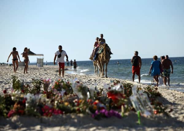 Tributes on the beach near the RIU Imperial Marhaba hotel in Sousse, Tunisia, as British holidaymakers defy the terrorists and continue to stay in Sousse despite the bloodbath on the beach. PRESS ASSOCIATION Photo. Picture date: Tuesday June 30, 2015. The sands at Sousse were quiet and calm today as tourists and locals alike continued to pay their respects to the 38 dead outside the RIU Imperial Marhaba and Bellevue hotels. Flowers continue to be laid at three heart-shaped memorials that mark where so many people lost their lives, with many people in tears as they read the messages of support in several languages that have been placed in the sand. See PA POLICE Tunisia stories. Photo credit should read: Steve Parsons/PA Wire