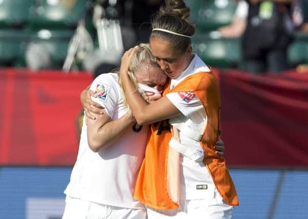 England's Josanne Potter, right, consoles Laura Bassett (6) after a 2-1 loss to Japan in a semifinal in the FIFA Women's World Cup soccer tournament. (Jason Franson/The Canadian Press via AP)