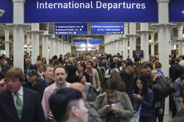 People at St Pancras International train station in London, as Eurostar suspended all services to Calais.