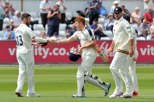 Jonny Bairstow is congratulated on his innings by Durham's Jamie Harrison.