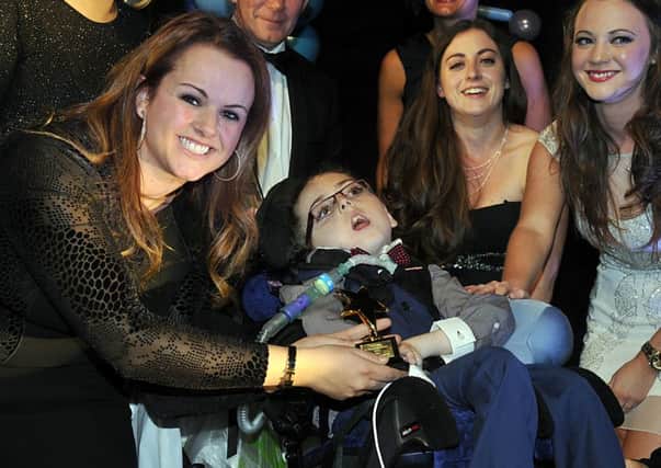 Claire Young presents the Outstanding Bravery award to Lewis Jeynes at the Yorkshire Children of Courage Awards 2014