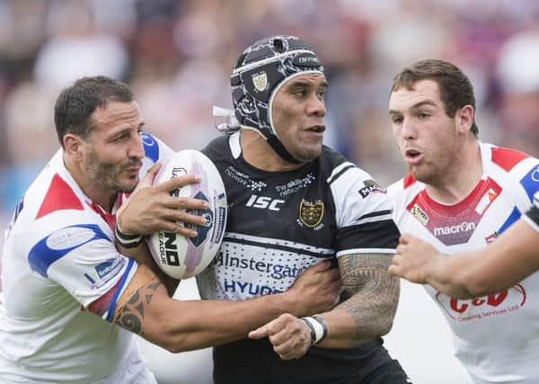 Wakefield's David Gilmour tangles with Hull FC's Mickey Paea.