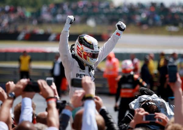 Mercedes Lewis Hamilton celebrates his victory during the 2015 British Grand Prix at Silverstone Circuit, Towcester. (Picture: David Davies/PA Wire).
