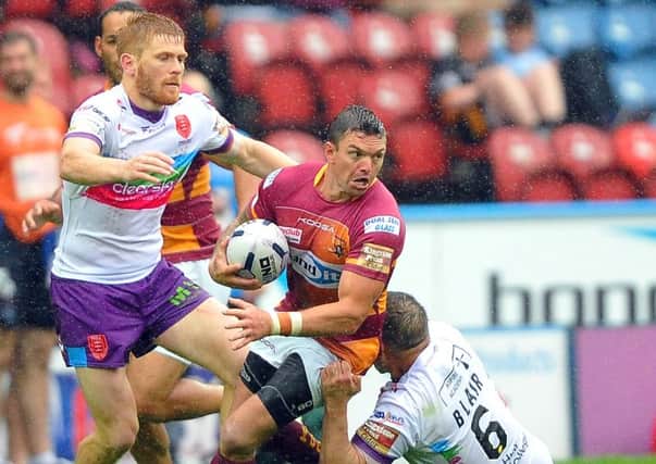 Huddersfield Giants' Danny Brough in action against Hull Kingston Rovers' Kris Welham and Maurice Blair. (Picture: John Rushworth)