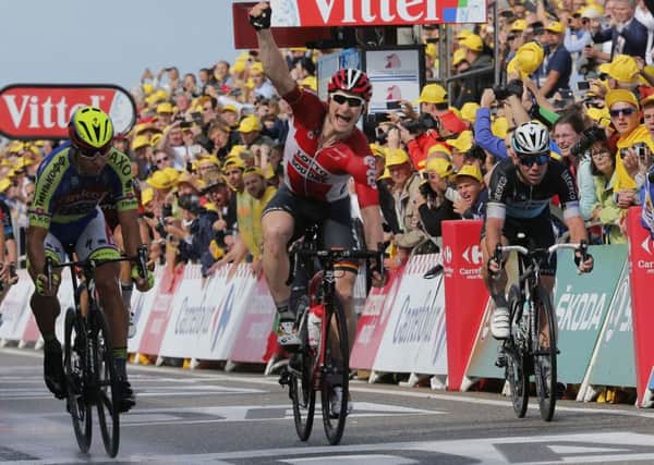Germany's Andre Greipel crosses the finish line ahead of Peter Sagan of Slovakia, left, and Britain's sprinter Mark Cavendish, right, to win the second stage of the Tour de France. (AP Photo/Christophe Ena)