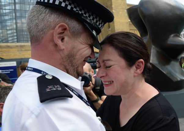 7/7 survivor Gill Hicks hugs PC Andy Maxwell, who came to her aid when she was injured.