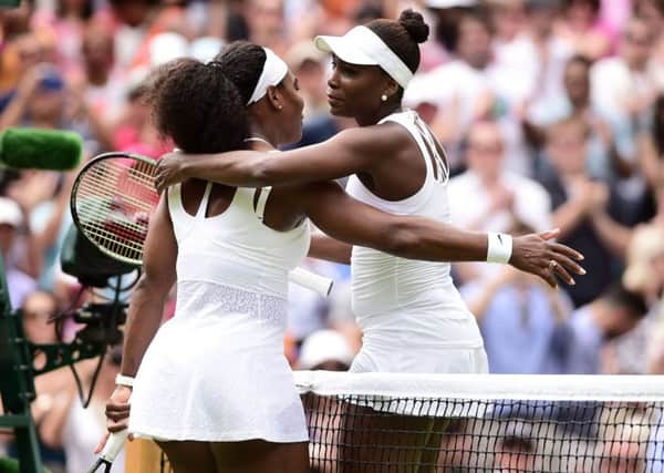 Serena Williams (left) and Venus Williams embrace after their match during day Seven of the Wimbledon Championships at the All England Lawn Tennis and Croquet Club, Wimbledon. (Picture: Adam Davy/PA Wire).
