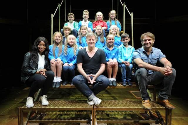 Jesus Christ Superstar performers Racel Adedeji, Glenn Carter and Tim Rogers with youngsters from The Stuart Stage School in Heckmondwike. Pic: James Hardisty.