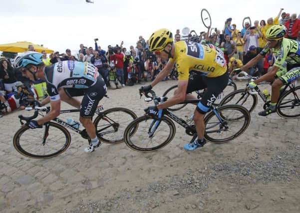 Stage winner Germany's Tony Martin, left, Britain's Christopher Froome, wearing the overall leader's yellow jersey, and Spain's Alberto Contador, right.
