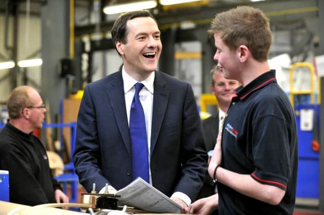 George Osborne talks to apprentice Jordan Hankin at Winder Power, Pudsey Picture Bruce Rollinson