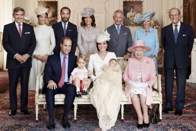 The Duke and Duchess of Cambridge with their children, Prince George, and Princess Charlotte, who was christened at Sandringham on Sunday July 5, 2015.  They are pictured in the Drawing Room of Sandringham House with Queen Elizabeth II (seated right) and (standing, from left), Michael Middleton, Pippa Middleton, James Middleton.