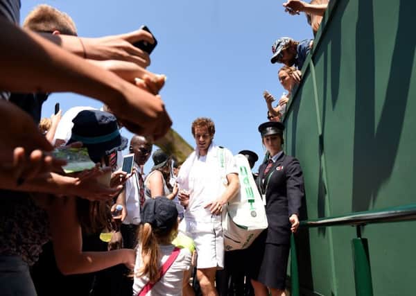 Andy Murray signs auotgraphs as he leaves court 15 after his practice session.