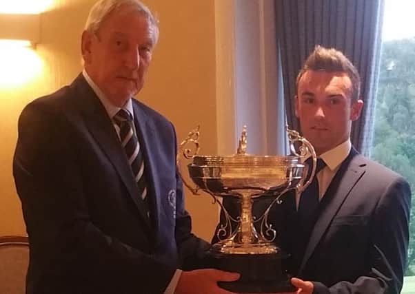 Meltham's Captain, Jim Hemmings, presents the Meltham Trophy to Lewis Collier, of Crosland Heath.