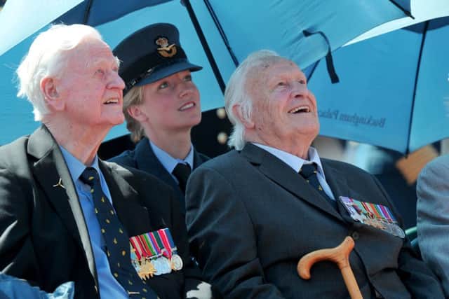 Battle of Britain veterans Wing Commander TF Neil, 249 Squadron Hurricaines (left) and Geoffrey Harris Augustus Wellum, 92 Squadron Spitfires (right) view an RAF fly-past to mark the 75th anniversary of the Battle of Britain