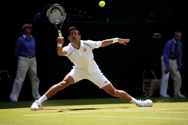 Novak Djokovic slides into action against Richard Gasquet during day 11 of the Wimbledon Championships