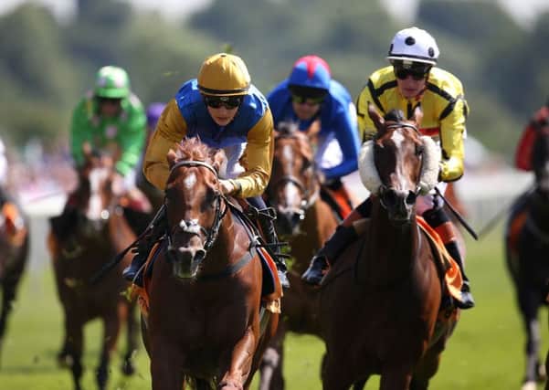 New Providence with jockey Harry Bentley (gold cap) winning the 888sport Summer Stakes at York.