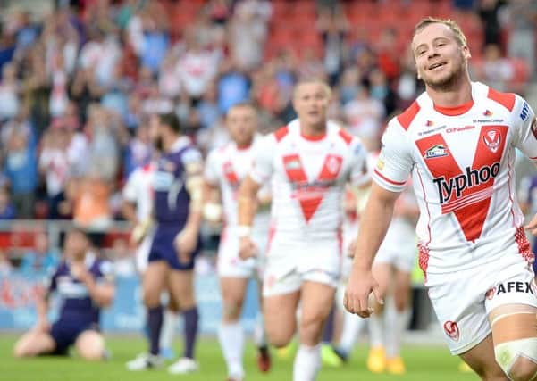 St Helens' Adam Quinlan celebrates his try against Huddersfield Giants.