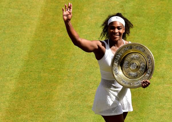 Serena Williams holds the Venus Rosewater Dish after her victory in the womens singles final against Garbine Muguruza. Picture: PA.