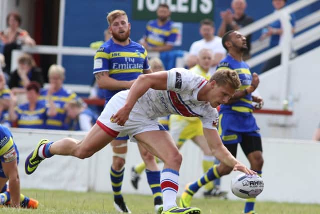 Wakefield's Jacob Miller scores a try.
