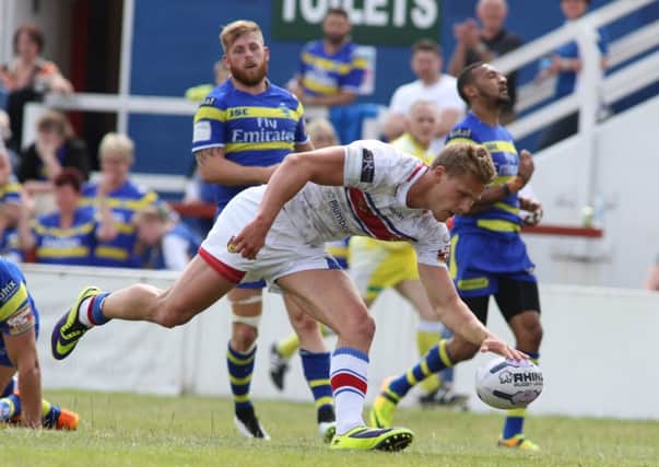 Wakefield's Jacob Miller scores a try.