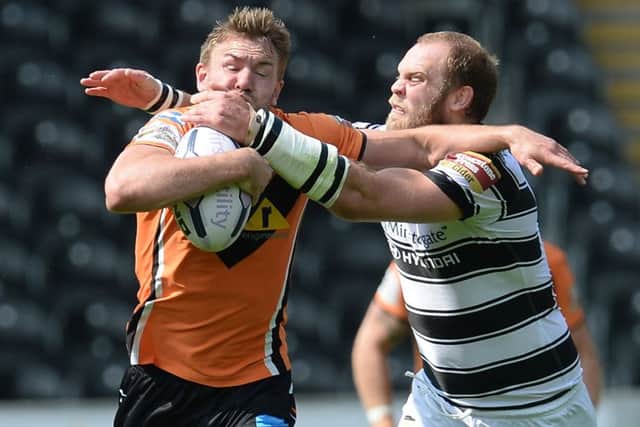 Castleford Tigers' Michael Shenton is tackled by Hull FC's  Richard Whiting.
