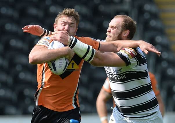 Castleford Tigers' Michael Shenton is tackled by Hull FC's  Richard Whiting.