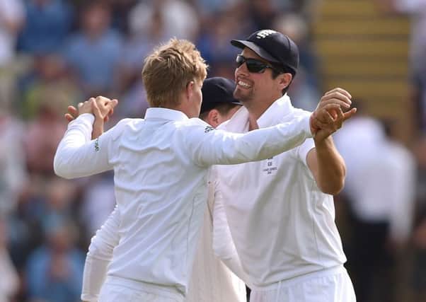 England's Joe Root (left) celebrates with captain Alastair Cook (right) after taking the wicket of Australia's Mitchell Johnson during the First Investec Ashes Test at the SWALEC Stadium, Cardiff. PRESS ASSOCIATION Photo. Picture date: Saturday July 11, 2015. See PA story CRICKET England. Photo credit should read: Joe Giddens/PA Wire. RESTRICTIONS: Editorial use only. No commercial use without prior written consent of the ECB. Still image use only no moving images to emulate broadcast. No removing or obscuring of sponsor logos. Call +44 (0)1158 447447 for further information