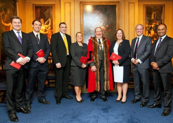 T & R Theakston Ltd Cooper Jonathan Manby (third from left) after being invested into the livery by Ian Frood, Master of the Worshipful Company of Coopers
