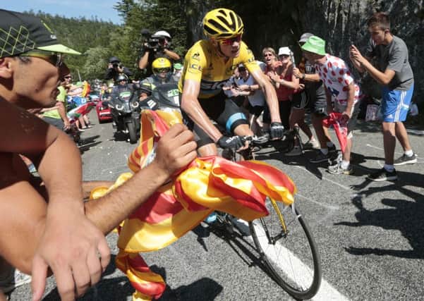Britain's Christopher Froome, wearing the overall leader's yellow jersey, rides breakaway to win the tenth stage of the Tour de France.