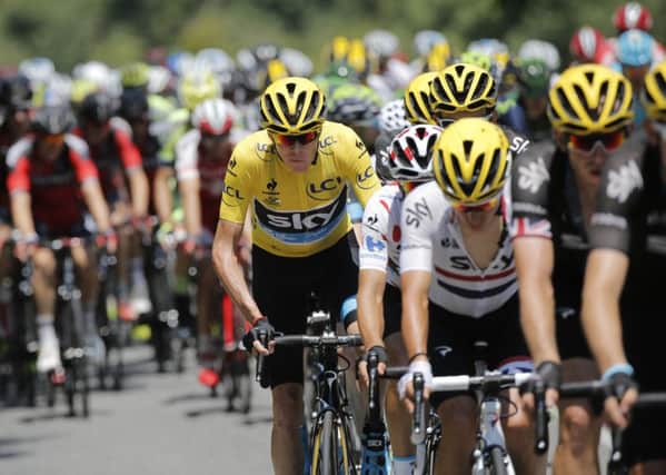 Britain's Chris Froome, wearing the overall leader's yellow jersey, rides in the pack during the eleventh stage of the Tour de France.